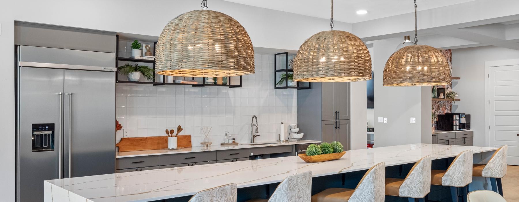 a kitchen with a bar large island and chairs