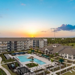 A beautiful community at the heart of all your passions a pool in a courtyard at dusk