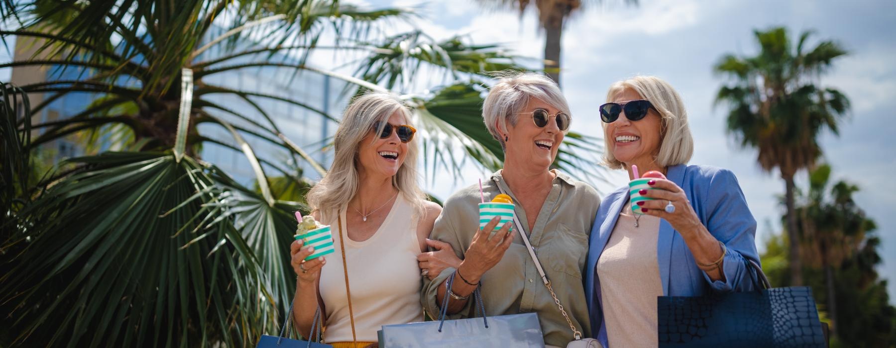 a group of women holding shopping bags