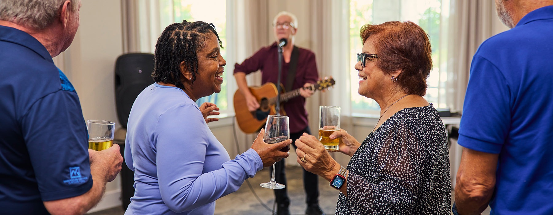 two women dancing with a glass of wine