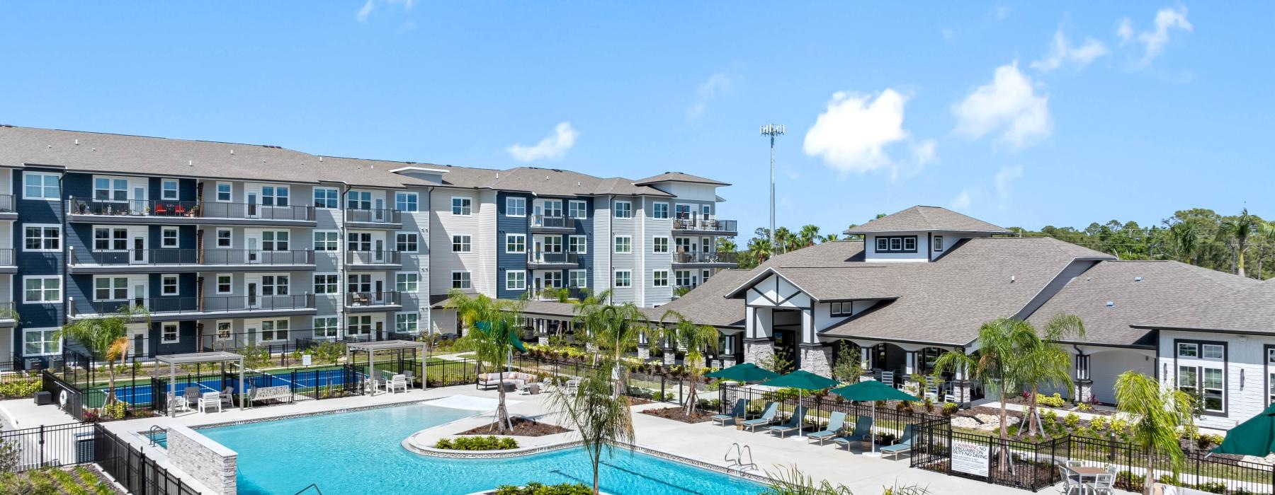 a large building with a pool in front of it