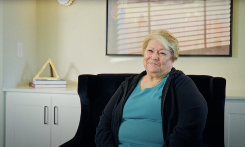 The essence of exceptional living a woman sitting in a chair smiling
