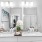 a bathroom with a large mirror sink and toilet