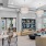 a lounge with seating tables and a bookshelf