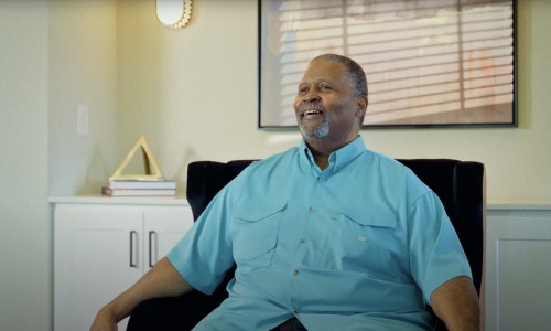 The essence of exceptional living a man wearing a blue shirt sitting in a chair