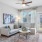 a living room with a fan couch and a table