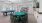 a game room with a pool table poker table tv and chairs