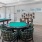 a game room with a pool table poker table tv and chairs